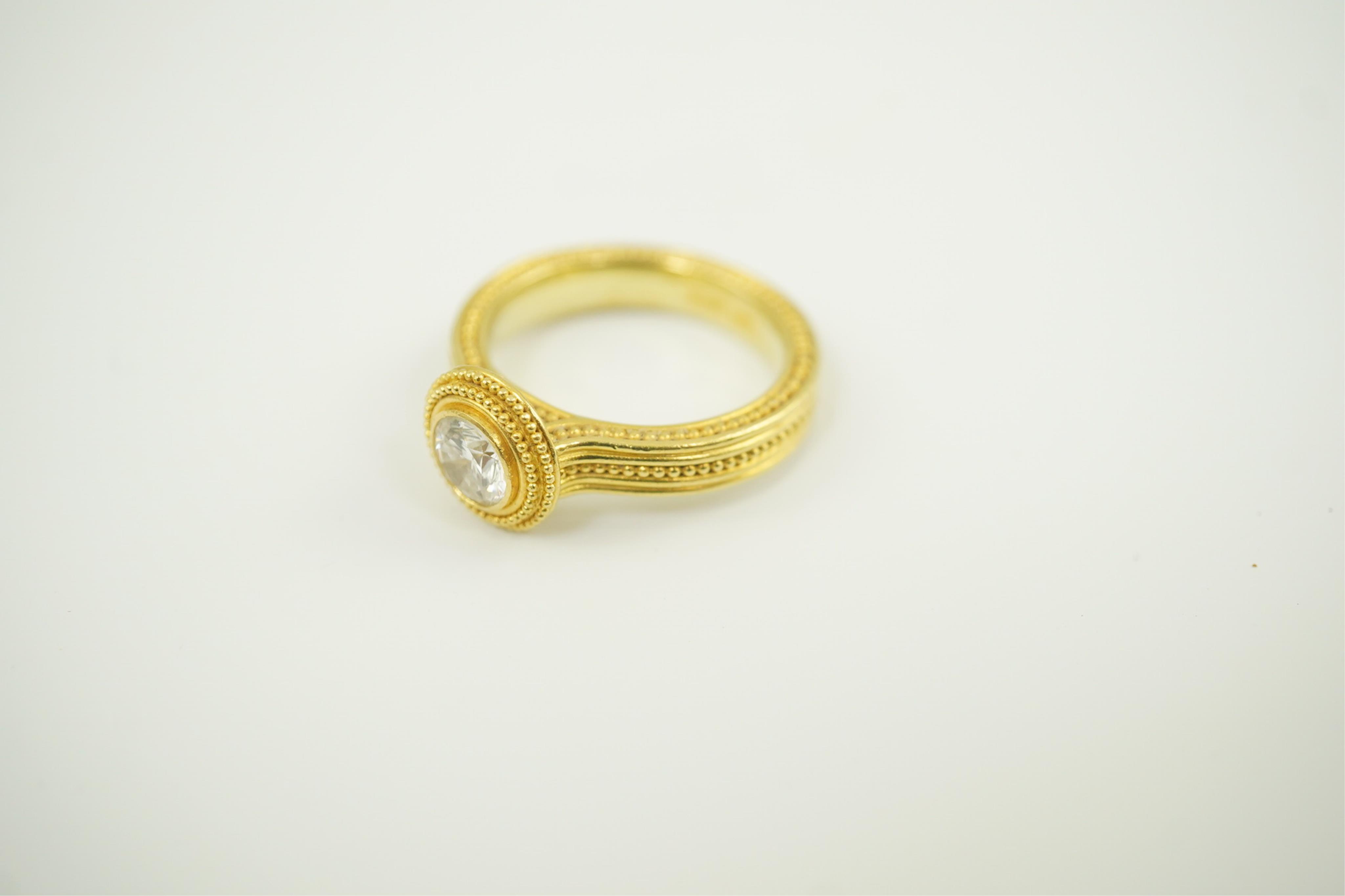 A 22ct gold collet set diamond dress ring